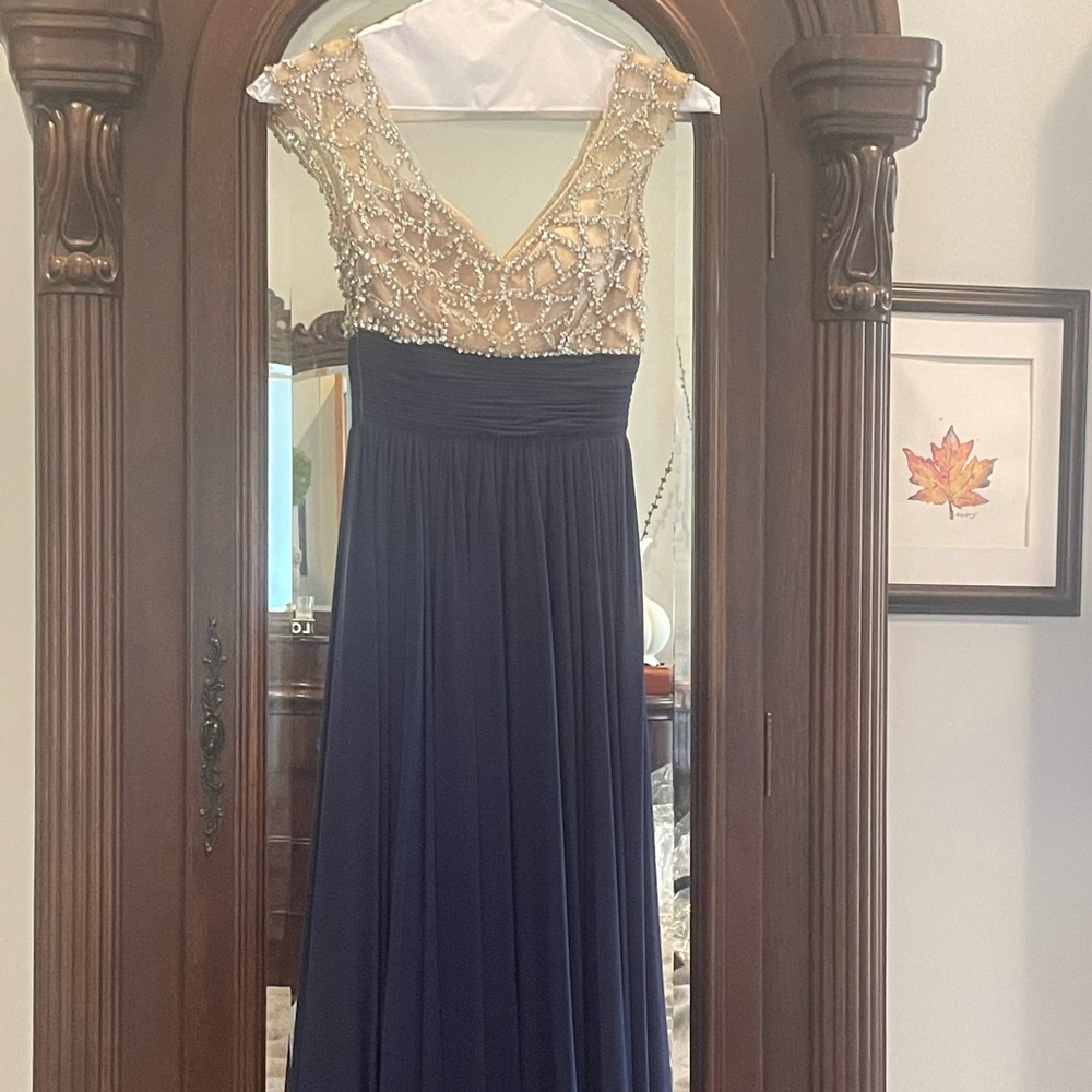 Floor length prom dress. Navy blue skirts with tan bodice, silver beading.